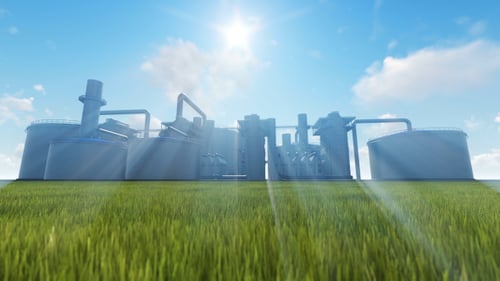 Industrial Plant in Green Field with Sun Rays and Blue Sky