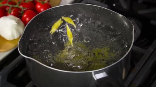 Farfalle Pasta Falling into Boiling Water