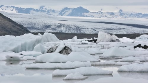 Floating Icebergs in Snowy Mountain Landscape