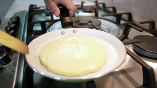 Pancake Cooking in Frying Pan on Stove