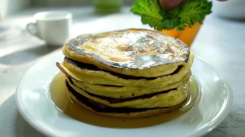 Pancakes Stacked High with Syrup and Mint