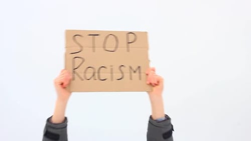 Young European Man Holding a Cardboard Box on His Outstretched Hands with the Inscription STOP