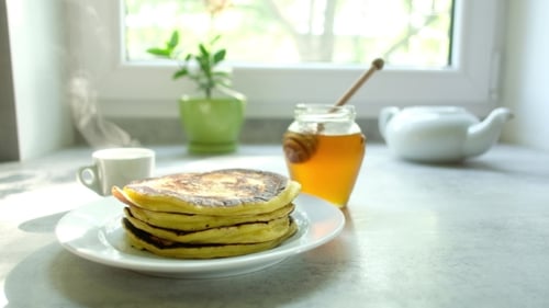 Stack of Pancakes with Honey for Breakfast