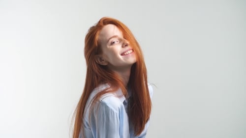 Red-haired Woman Posing and Smiling in Studio