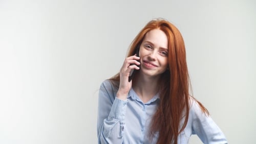 Smiling Woman Talking on Cellphone Indoors