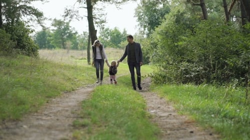 Happy Family Walking Together on Forest Path