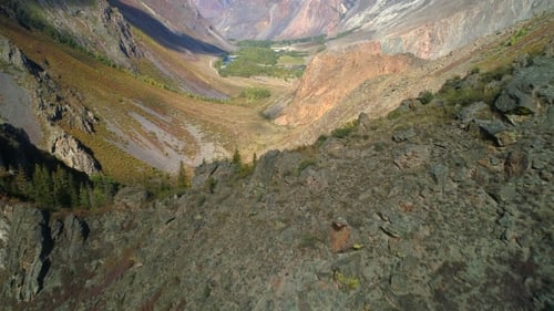 Aerial Footage. Flying Over a Mountain Ridge and Valley. . Rocky Terrain