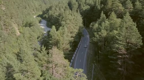 Beautiful View From Above Car Moving Along Road Among Green Forest To Mountains