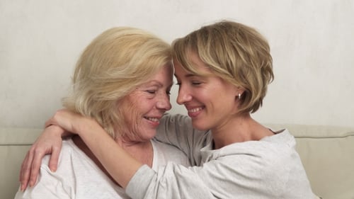 Blond Mother and Adult Daughter Embracing Affectionately