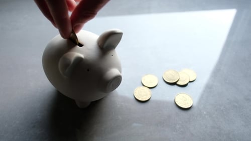 Depositing Coins in Ceramic Piggy Bank