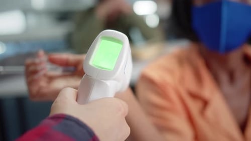 Temperature Check With Digital Thermometer in Workplace