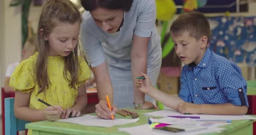 Creative Kids During an Art Class in a Daycare Center or Elementary School Classroom Drawing with