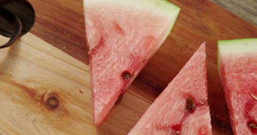 Slices of watermelon arranged on chopping board