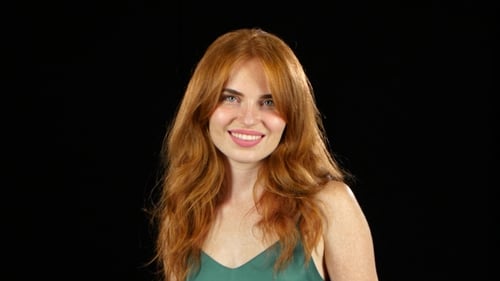 Happy Woman Gives a Thumbs Up on Black Background