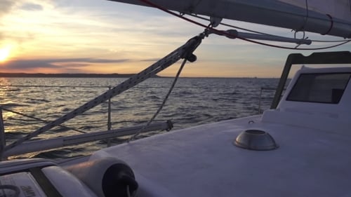 Sunset Sailboat Ride Over Calm Ocean Water