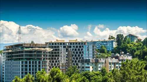 Building A House Surrounded By Trees And Clouds