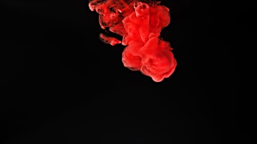 Swirling Red Ink Cloud on Black Background