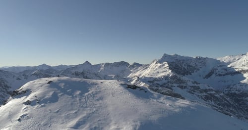 Snowy Mountain Range Under Clear Blue Sky