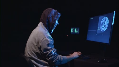 Hooded Person Threatened with Gun at Computer