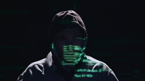 Dark Figure in Hood with Computer Code Projection