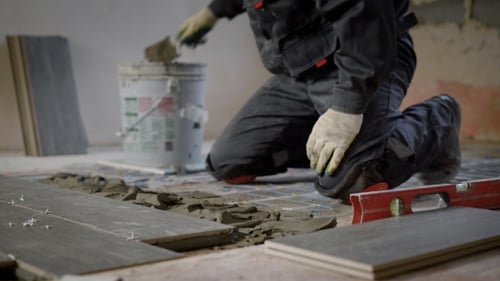 Tiler Is Applying a Building Mixture on a Floor for Montage of Ceramic Tiles