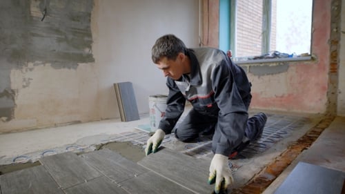 Tile Installation by a Construction Worker Indoors