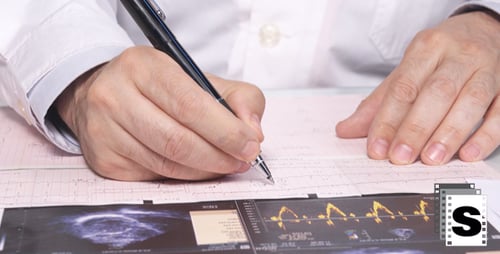 Doctor Looking Cardiogram