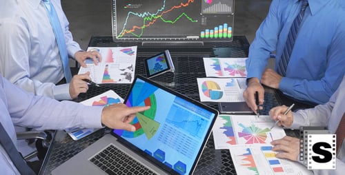 Business Team Analyzes Data Together at Table