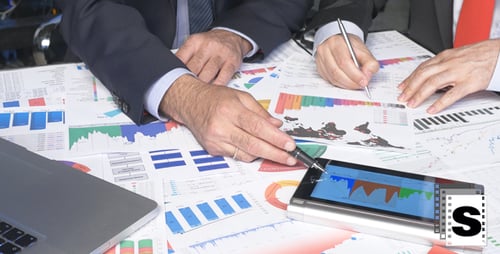 Businesspeople Analyzing Data at an Office Workplace