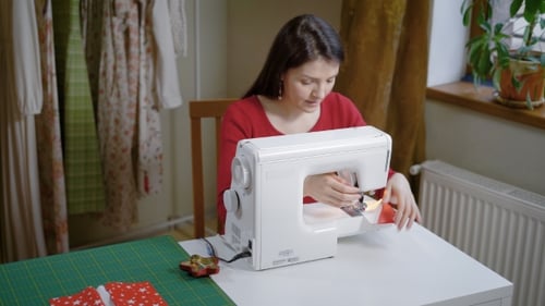 Fashion Designer Is Sewing in Her Home Workshop in Day, Making Stitch By Sewing Machine