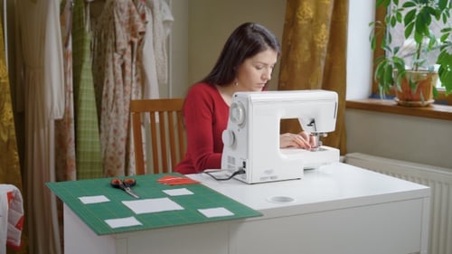 Beautiful Brunette Woman Is Adjusting Sewing Machine