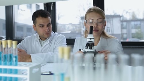Researchers Microscoping in Biochemistry Lab