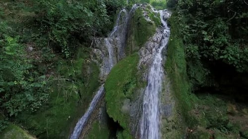 Scenic Waterfall Cascading Down Mossy Rock Face