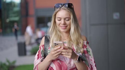 Young Woman Using Smartphone on Street