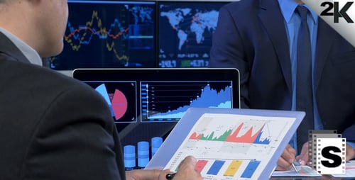 Business People Analyzing Charts and Graphs in Office
