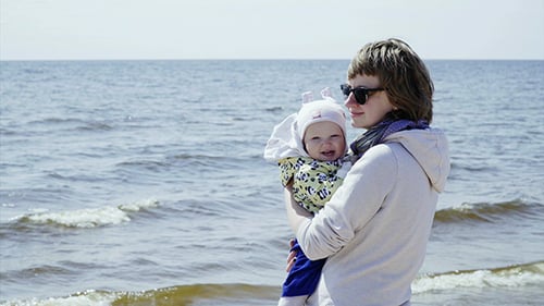 Mother and Happy Baby at Sunny Beach