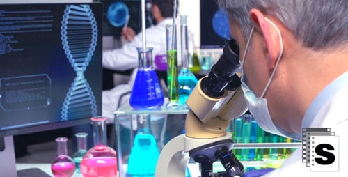 Chemist Looking Through Microscope