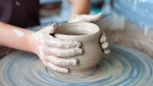 Creating a Clay pot.Potter.Workshop of clay.Clay on the device.Master.Hands Working on Pottery Wheel