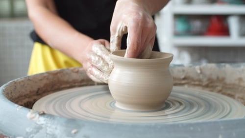 Pottery Class Workshop. Clay Shaping on Potter's Wheel. Potter Teaches His Craft To the Children.