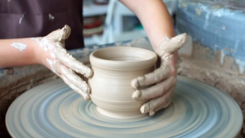 Hands Shaping Clay into Bowl on Pottery Wheel