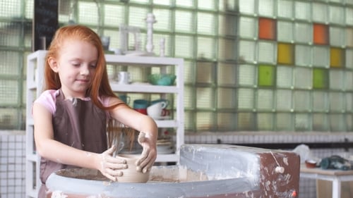 Little Girl Shaping Clay on Pottery Wheel
