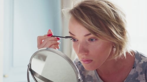 Blonde Woman Applying Makeup at Home