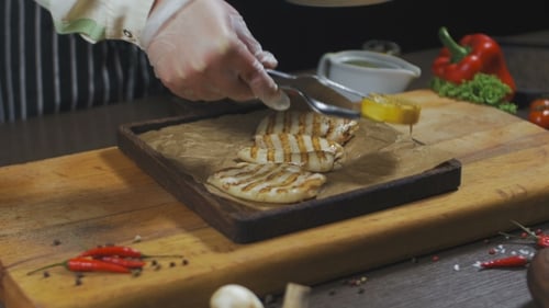 Chef Places Grilled Squid on Serving Board