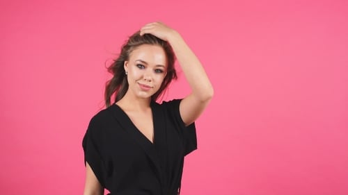 Brunette Woman Posing Fashionably on Pink Background