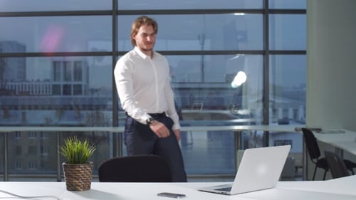 Portrait of Young Attractive Businessman Working at a Desk, Use Laptop in Office