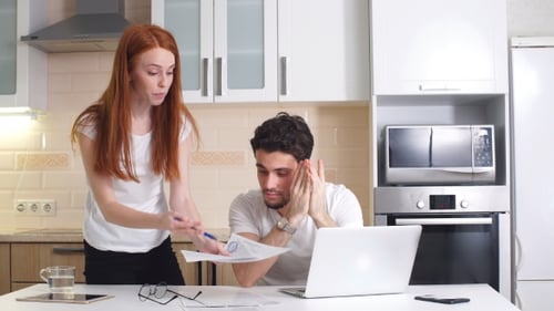 Woman and Man Reviewing Documents Together at Home