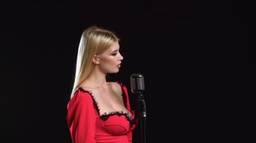 Elegant Woman Sings into Retro Microphone