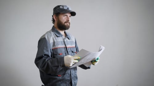 Portrait of an Architect Builder Studying Layout Plan of the Room