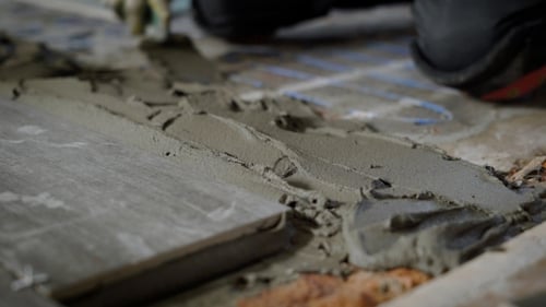 Applying Adhesive for Tiling on Construction Site