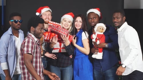 Happy Friends Celebrating Christmas Together with Gifts